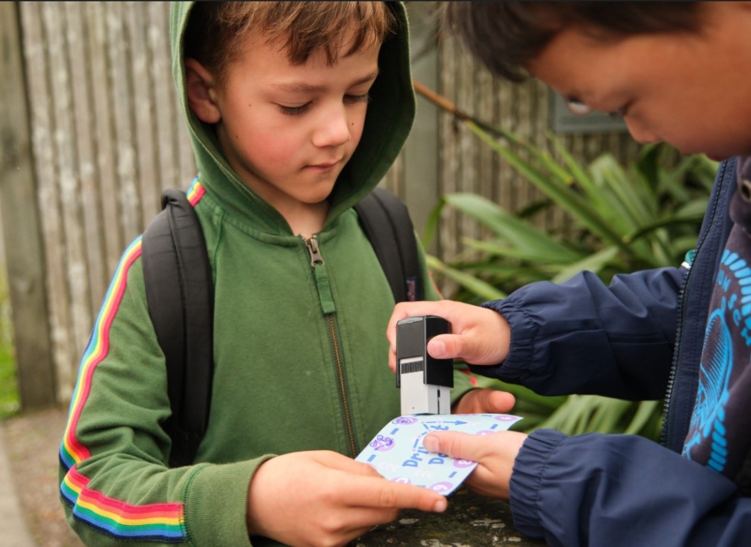 One student stamps another's ten-trip card