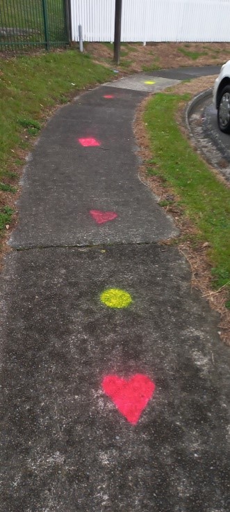 Marks painted on the footpath outside Papakowhai School